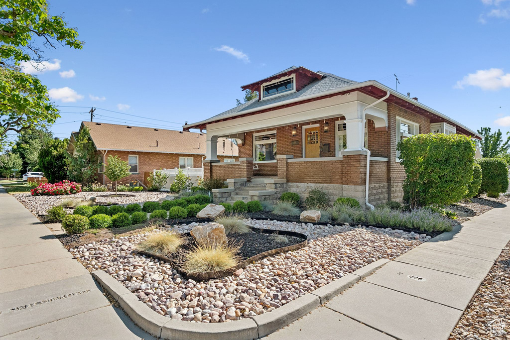 View of front of property with brick siding and a porch