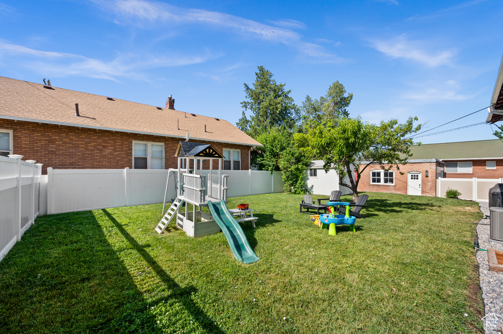 Fenced backyard with a playground