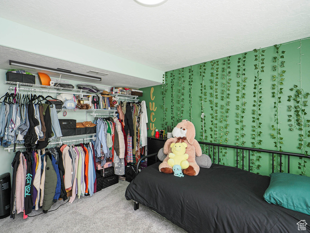 Bedroom with carpet and a closet