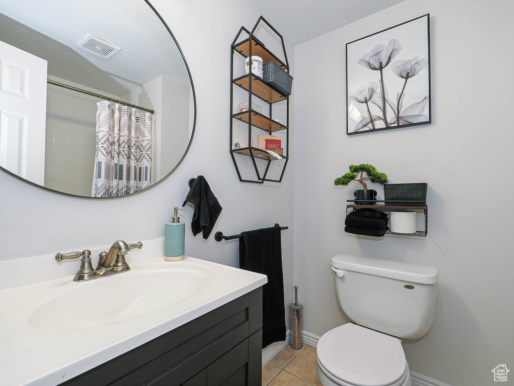 Full bathroom with vanity and tile patterned floors