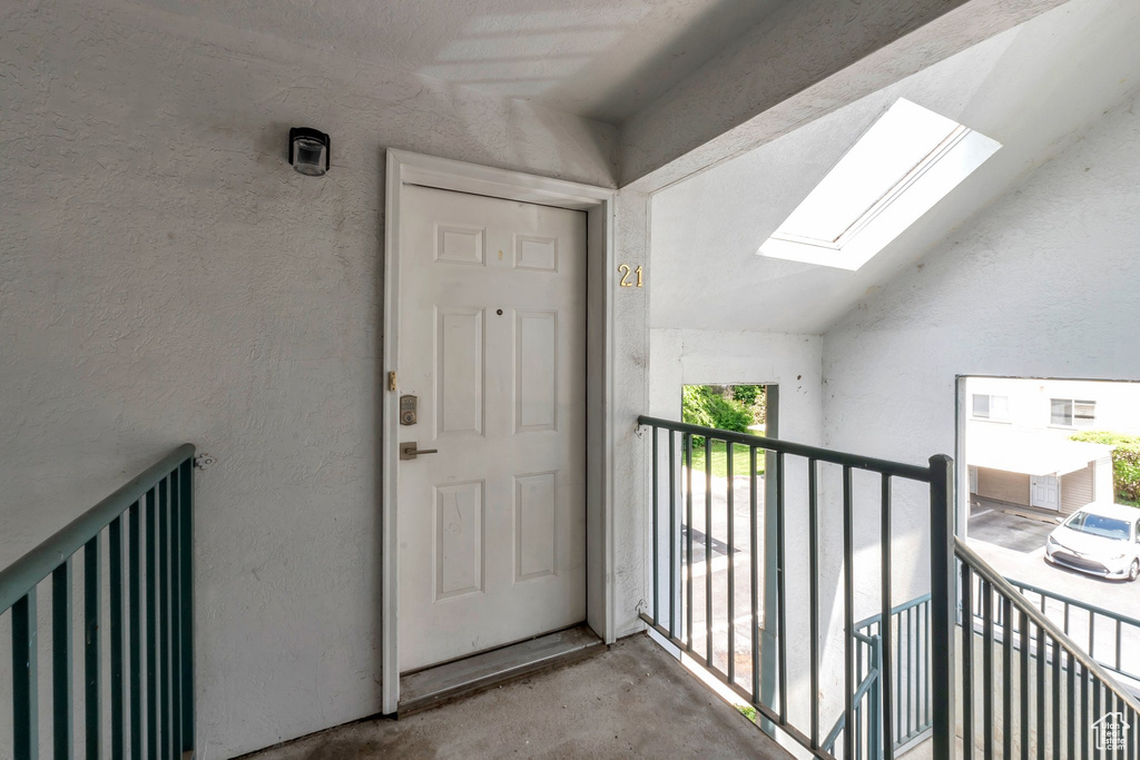 View of exterior entry with a balcony