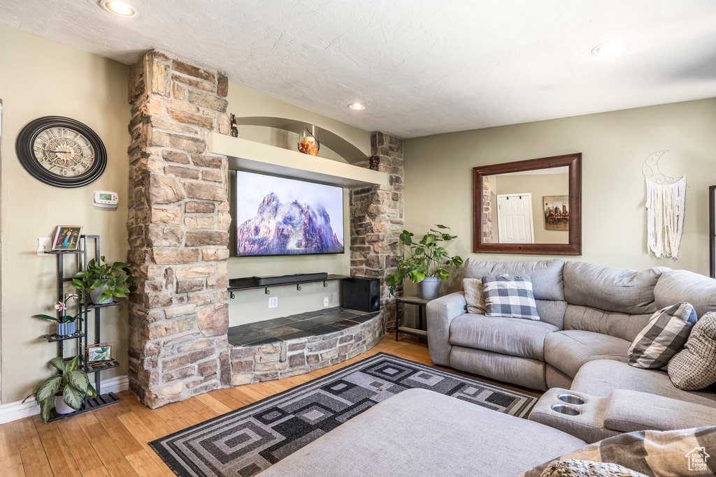 Living room with hardwood / wood-style floors and recessed lighting