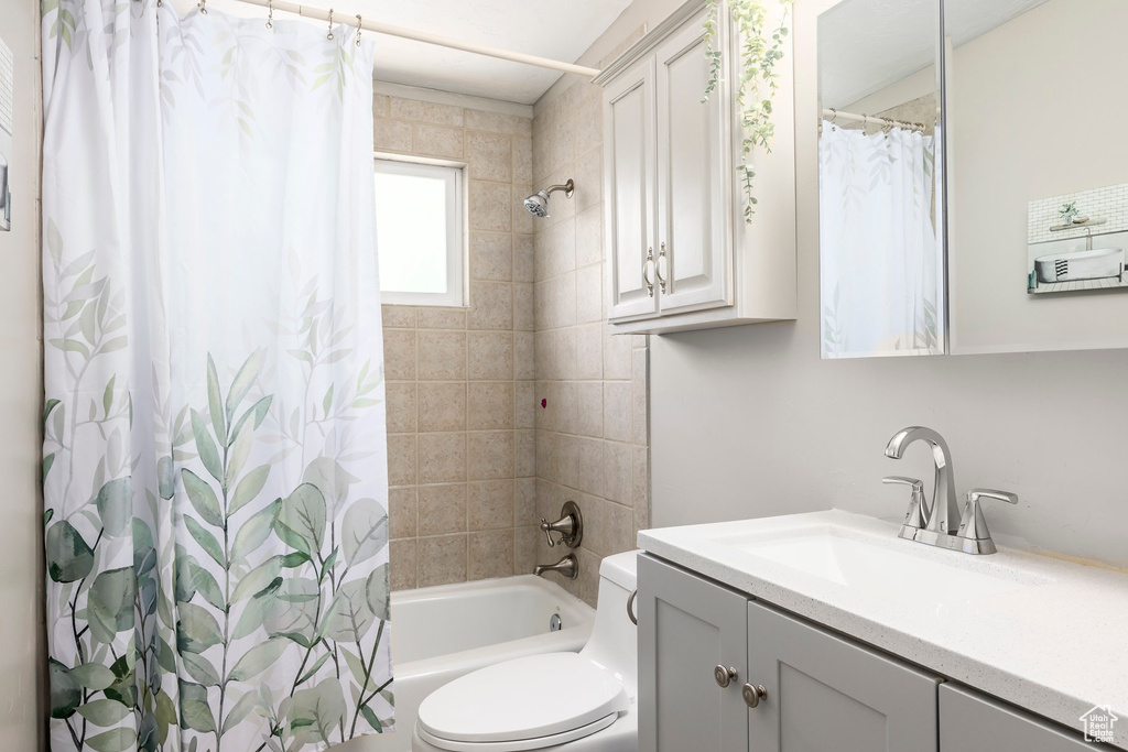 Full bathroom featuring vanity and shower / bath combination with curtain