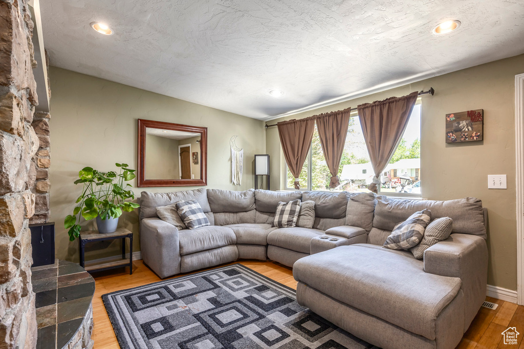 Living area featuring light wood-style flooring and recessed lighting