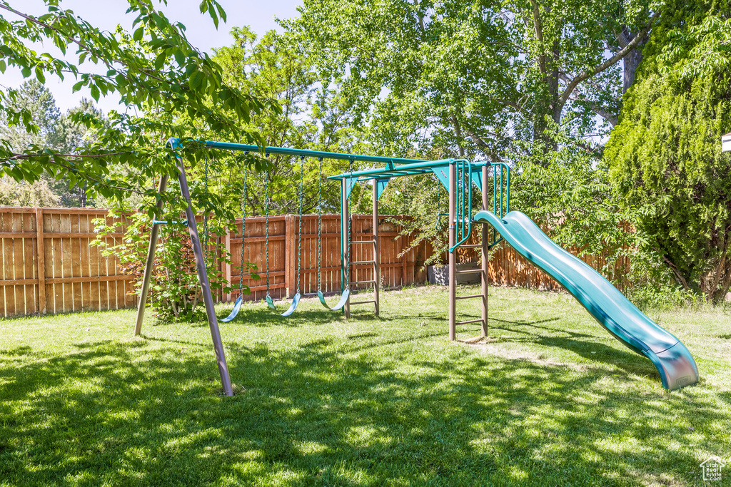 View of playground featuring a fenced backyard