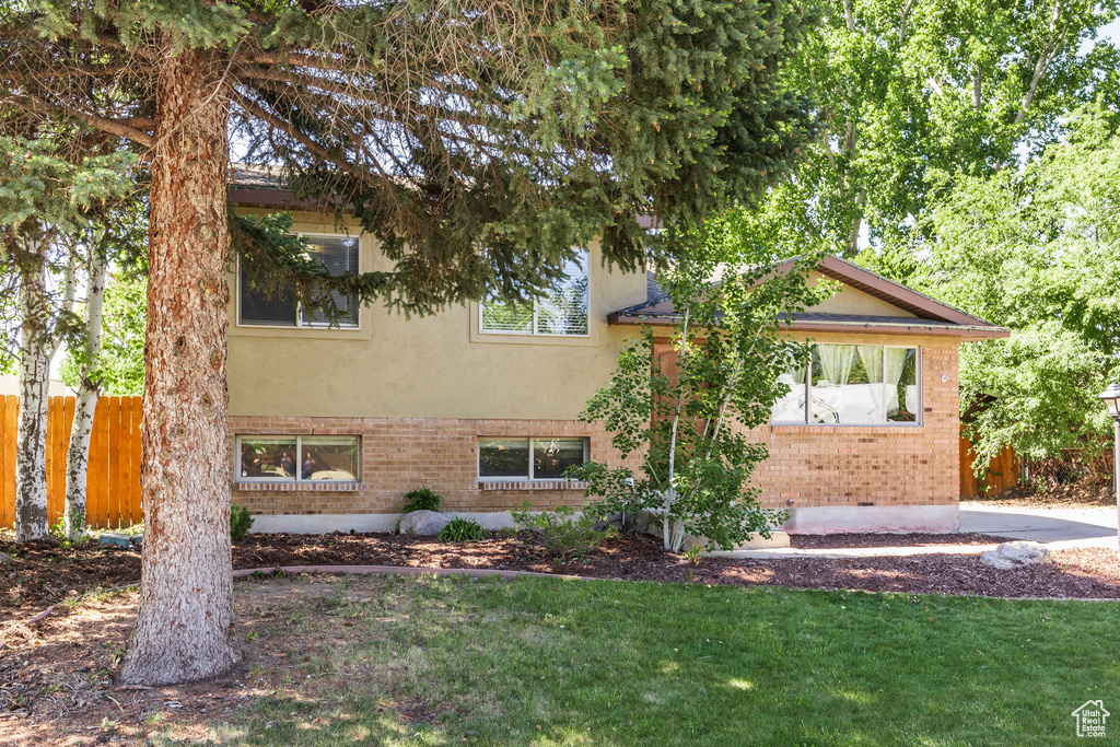 View of front of home with brick siding and stucco siding