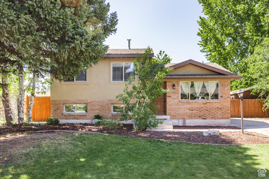 Split level home with brick siding and entry steps