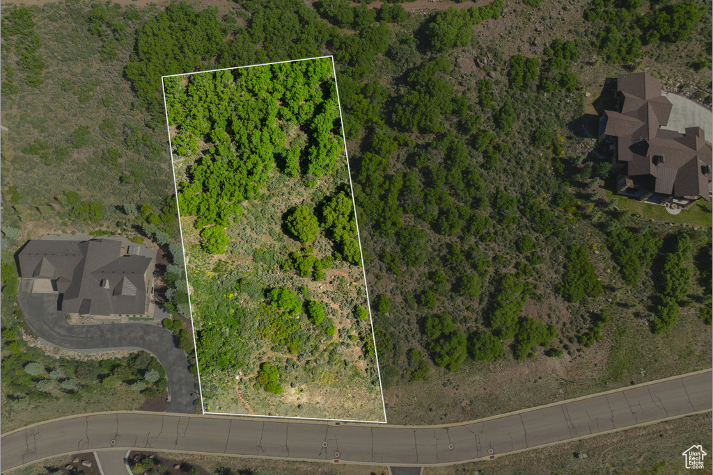 Aerial view of property and surrounding area featuring property parcel outlined