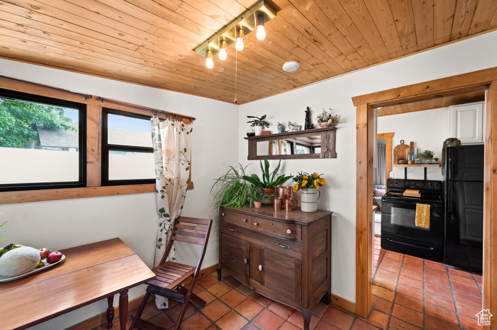 Tiled dining area featuring wooden ceiling and rail lighting