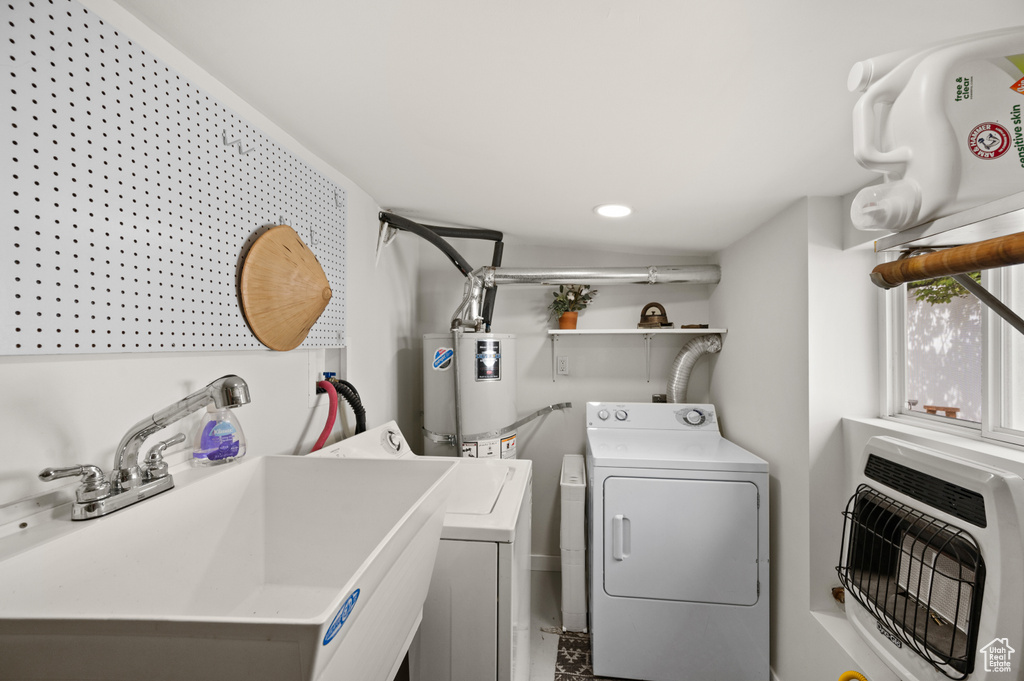 Washroom with heating unit, separate washer and dryer, water heater, and recessed lighting