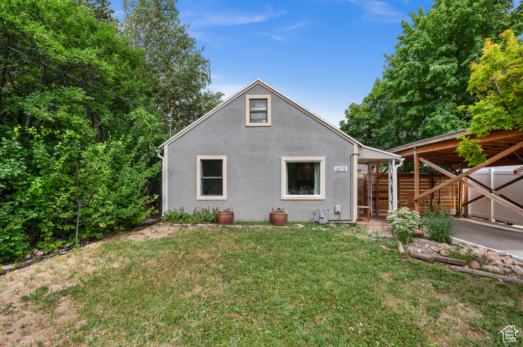 Back of house featuring stucco siding