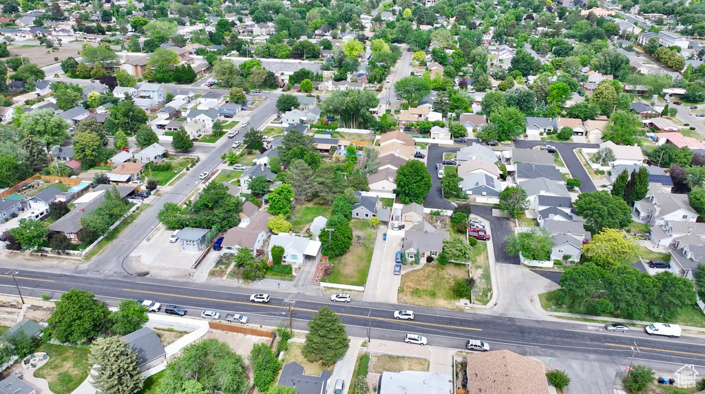 Aerial view of property and surrounding area with nearby suburban area