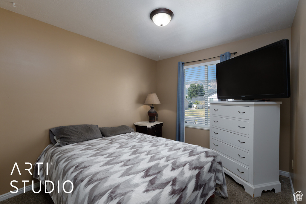 Carpeted bedroom featuring baseboards