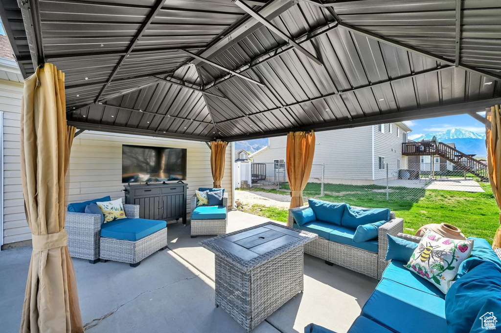 View of patio with an outdoor hangout area and a gazebo