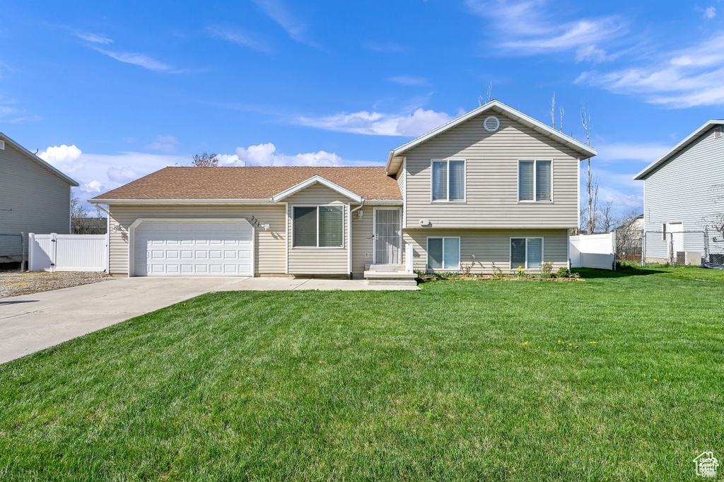 Split level home with a garage and concrete driveway