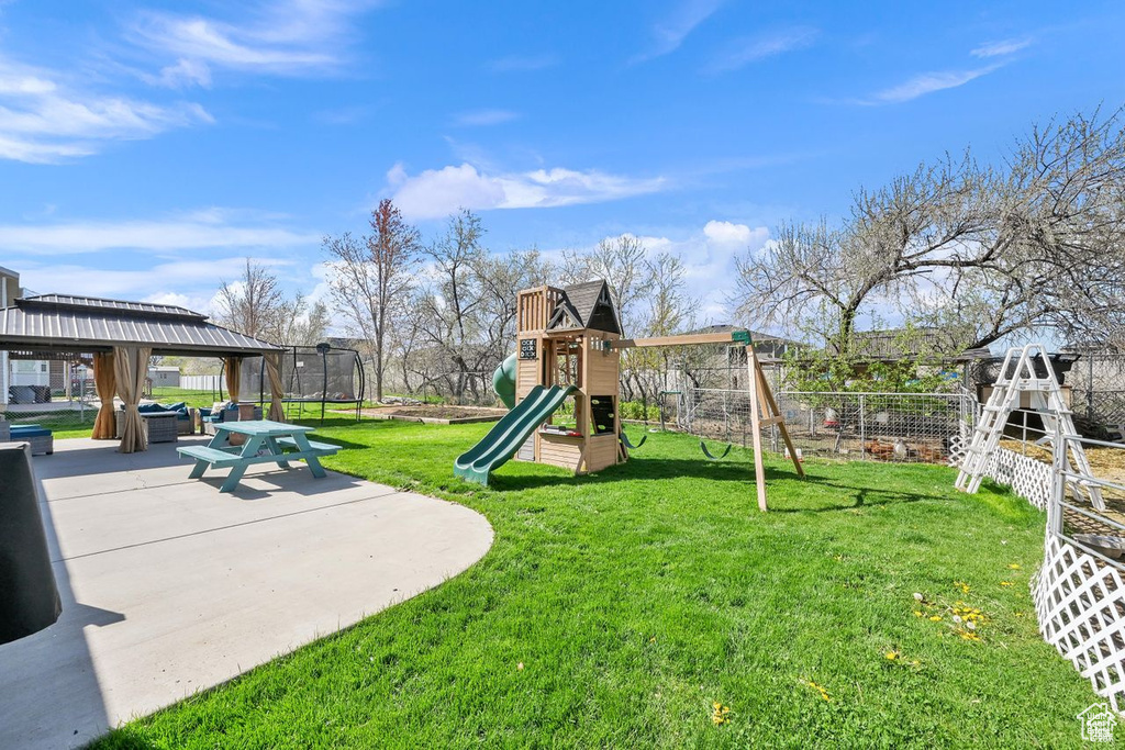 View of yard with a gazebo and a trampoline