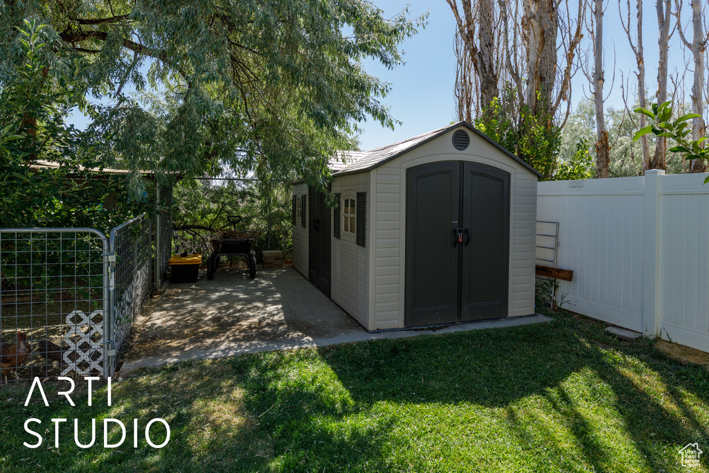 View of shed with a fenced backyard