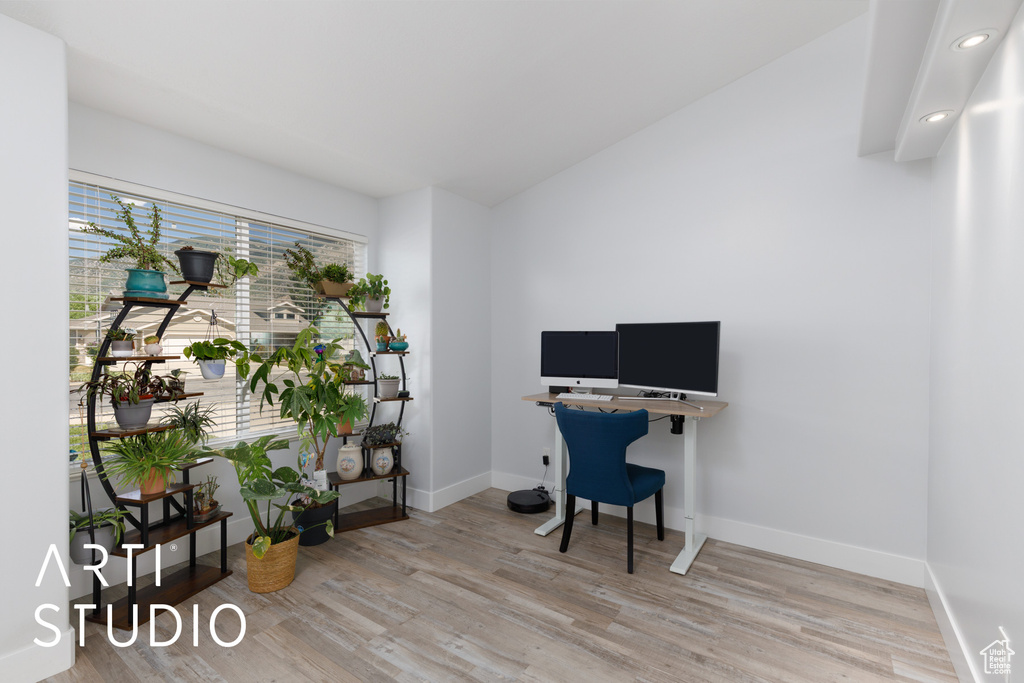 Home office featuring light wood-style floors, recessed lighting, and lofted ceiling