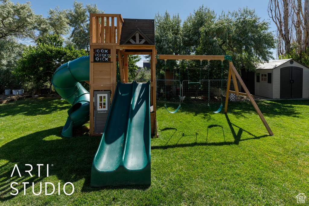 View of playground featuring a shed