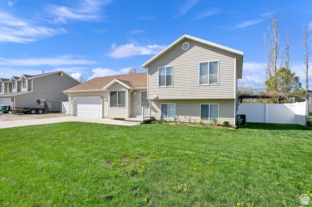 Split level home with an attached garage and driveway