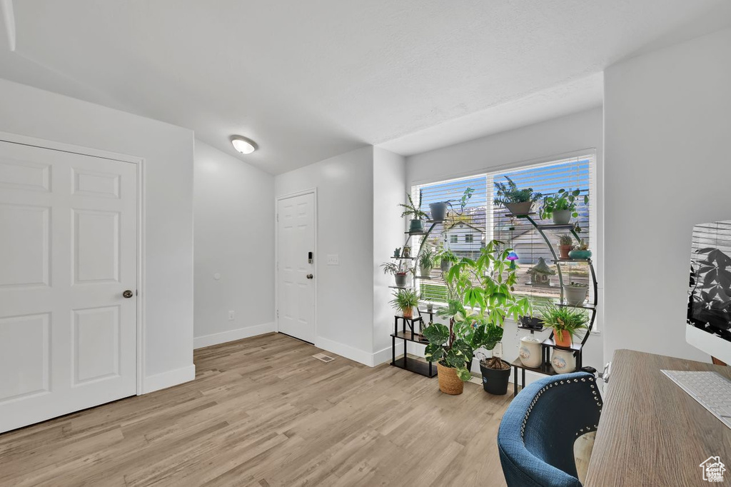 Foyer entrance featuring light wood-type flooring and baseboards