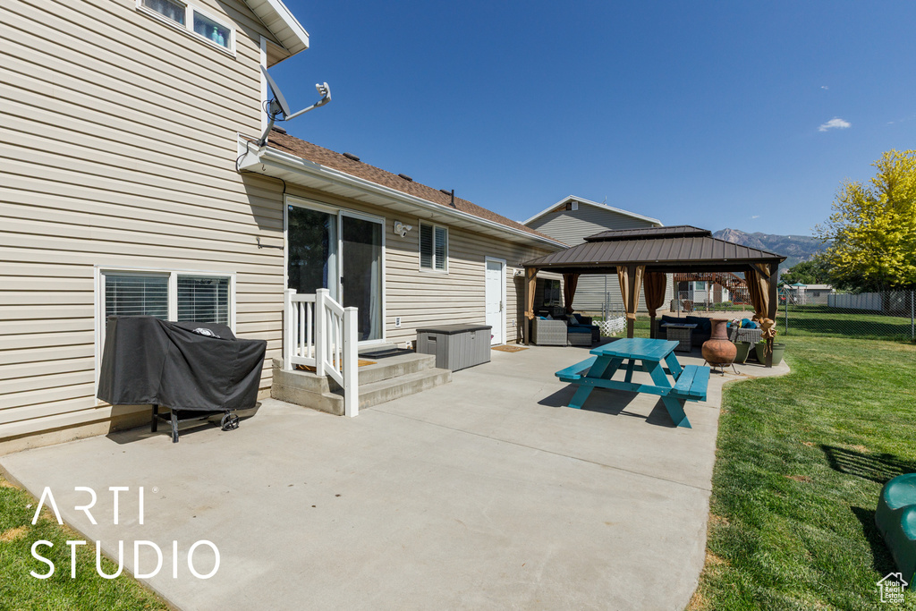 View of patio with outdoor lounge area, a gazebo, and grilling area