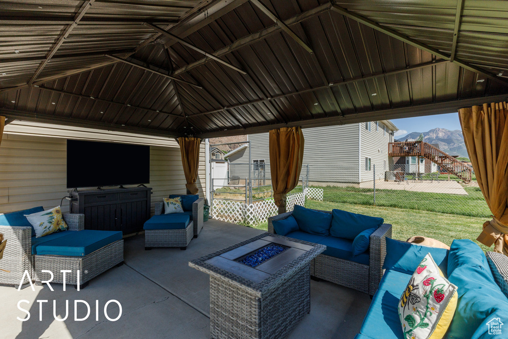 View of patio / terrace with an outdoor living space with a fire pit, a gazebo, and a mountain view