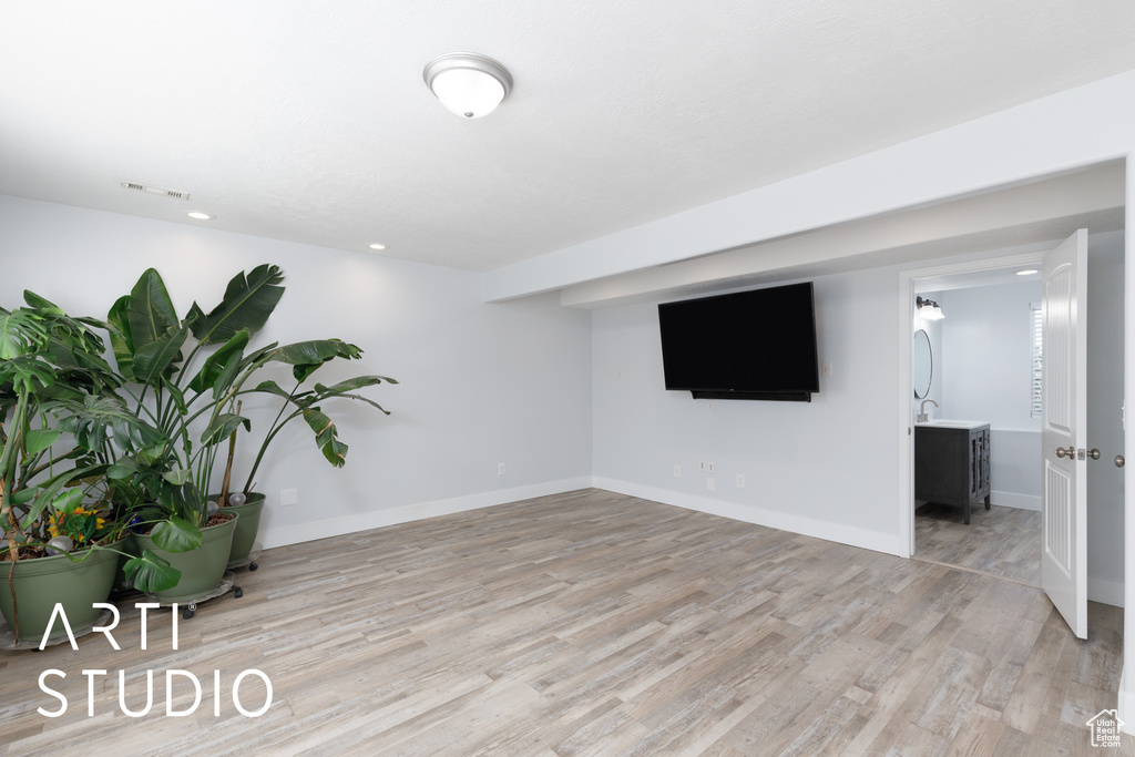 Basement featuring light wood finished floors and baseboards