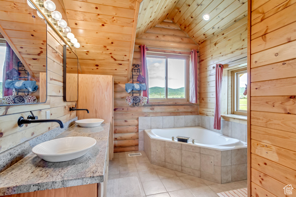 Full bathroom with a garden tub, double vanity, vaulted ceiling, wood ceiling, and tile patterned flooring