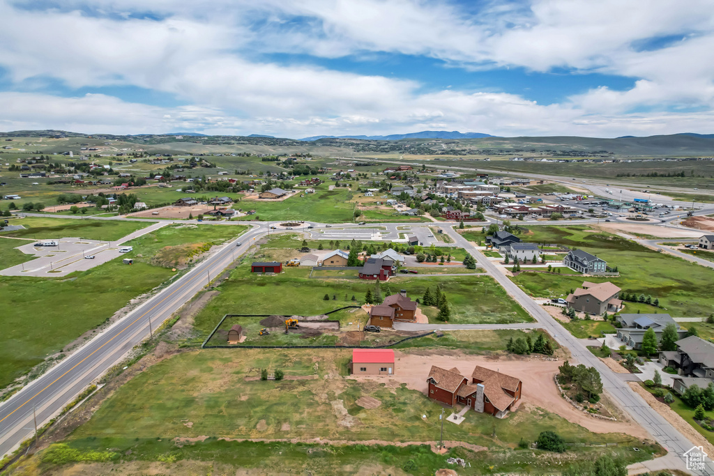 Aerial perspective of suburban area featuring a mountain backdrop and property boundaries highlighted