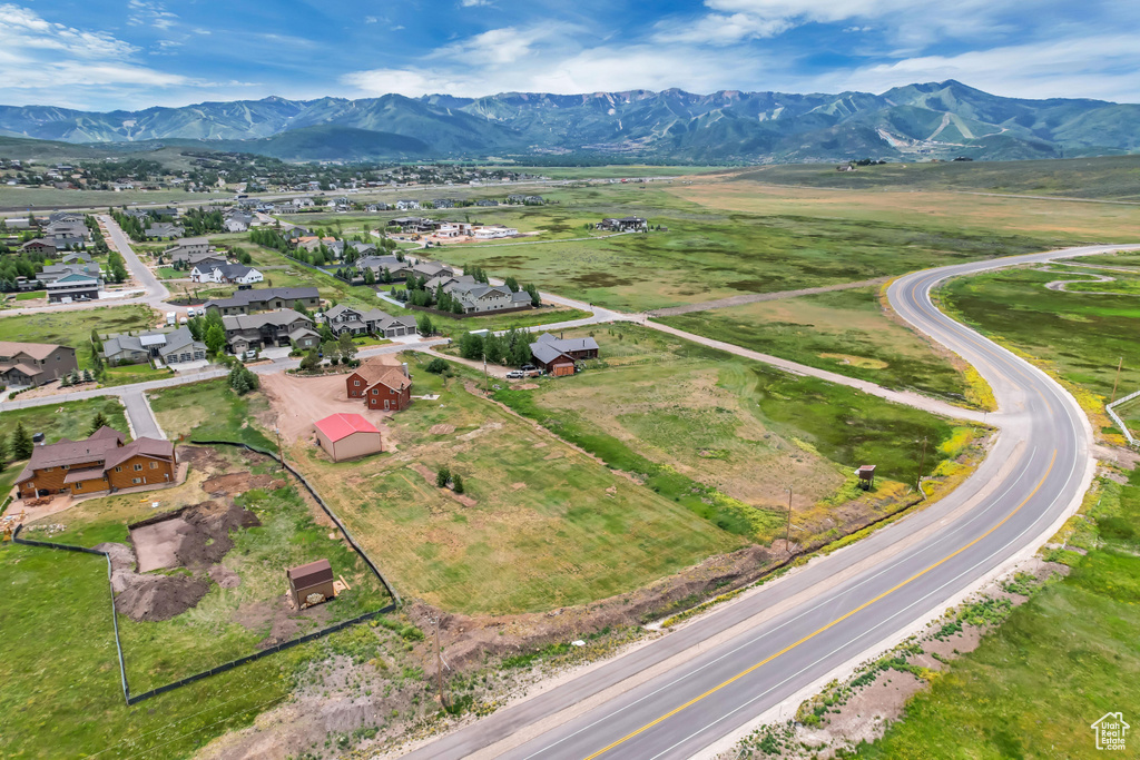 Aerial perspective of suburban area featuring a mountain backdrop