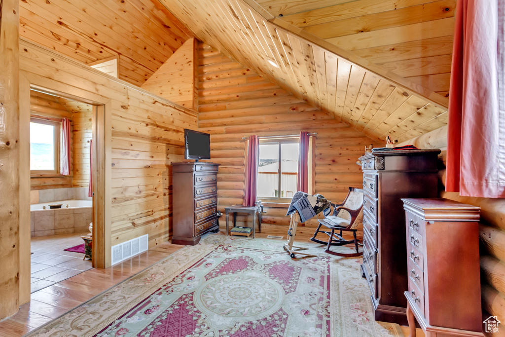Office area with rustic walls, lofted ceiling, wooden ceiling, and wood finished floors