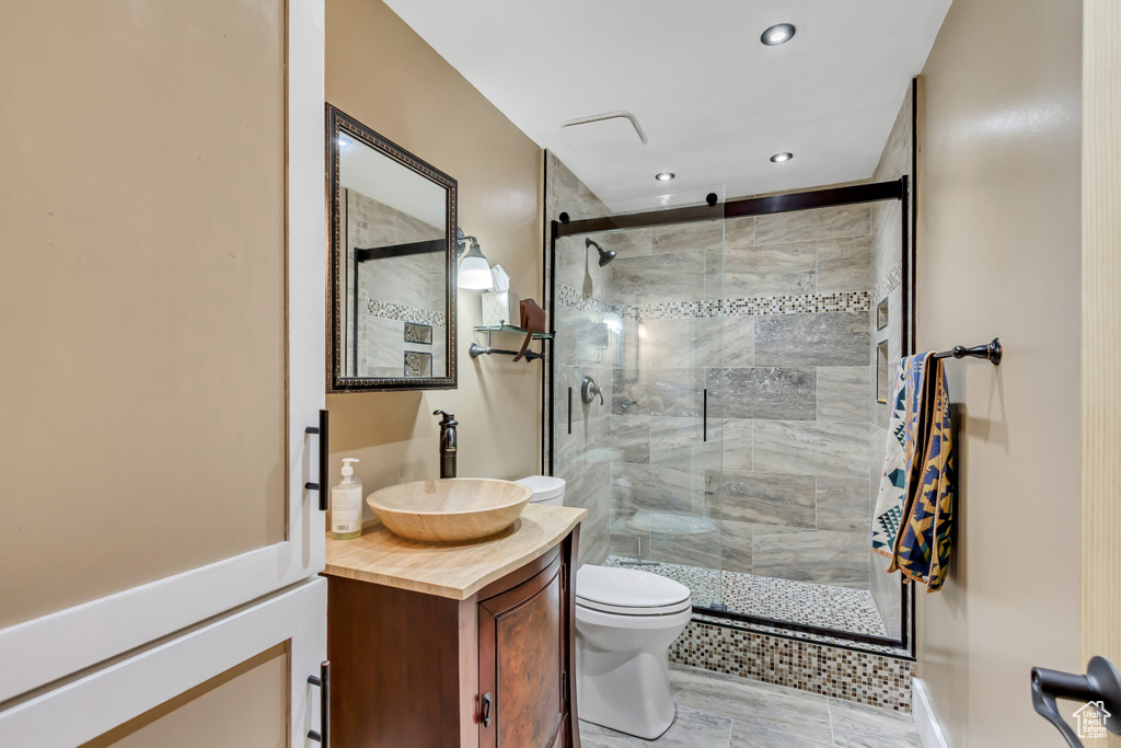 Full bathroom with vanity, a stall shower, and recessed lighting