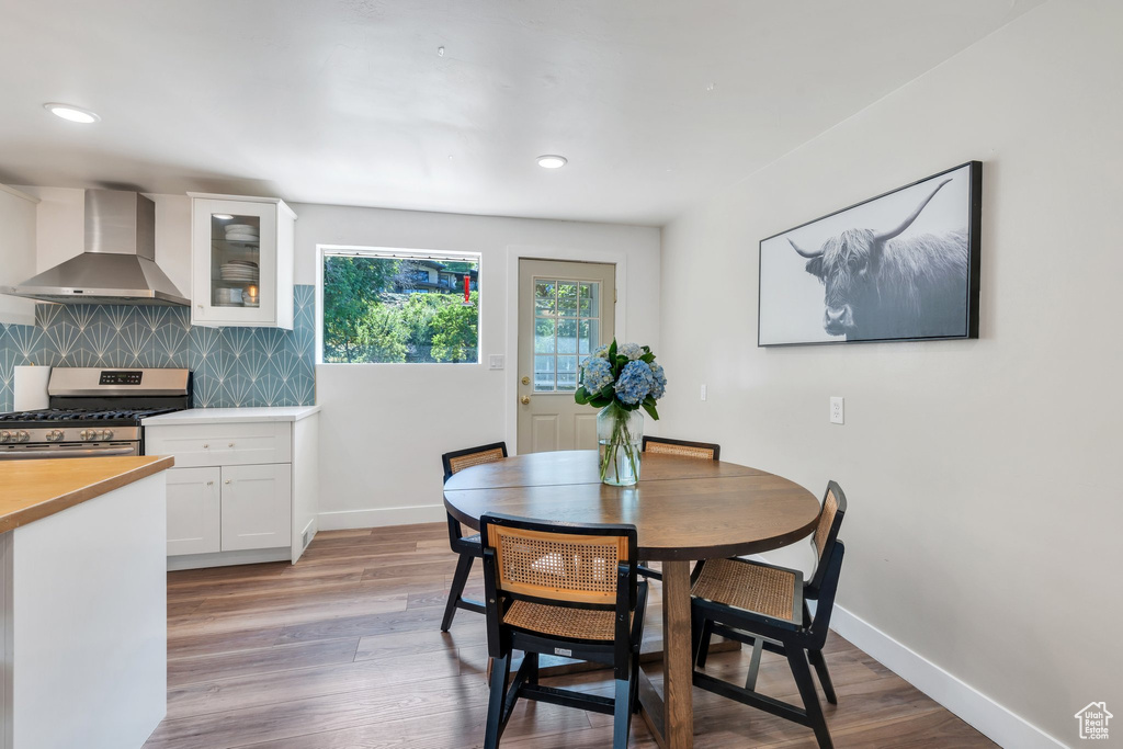 Dining area featuring light wood-style floors and recessed lighting