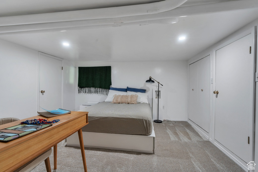 Bedroom with light colored carpet and recessed lighting