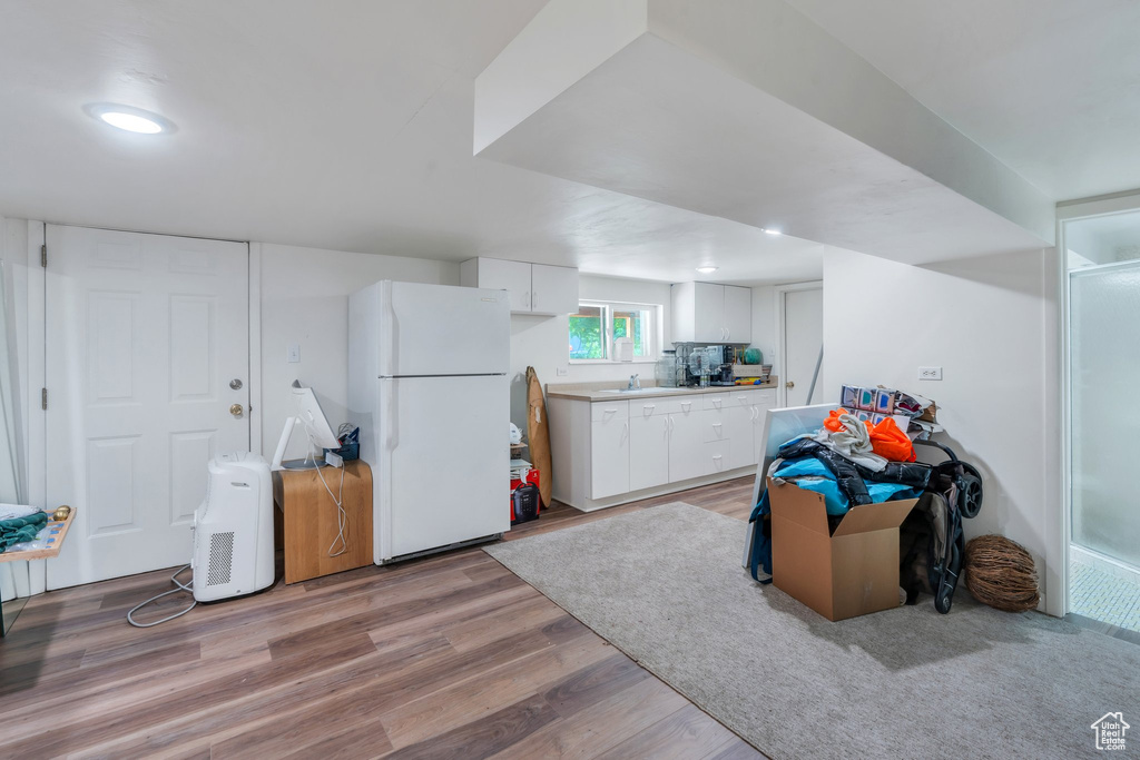 Playroom with light wood finished floors and a sink