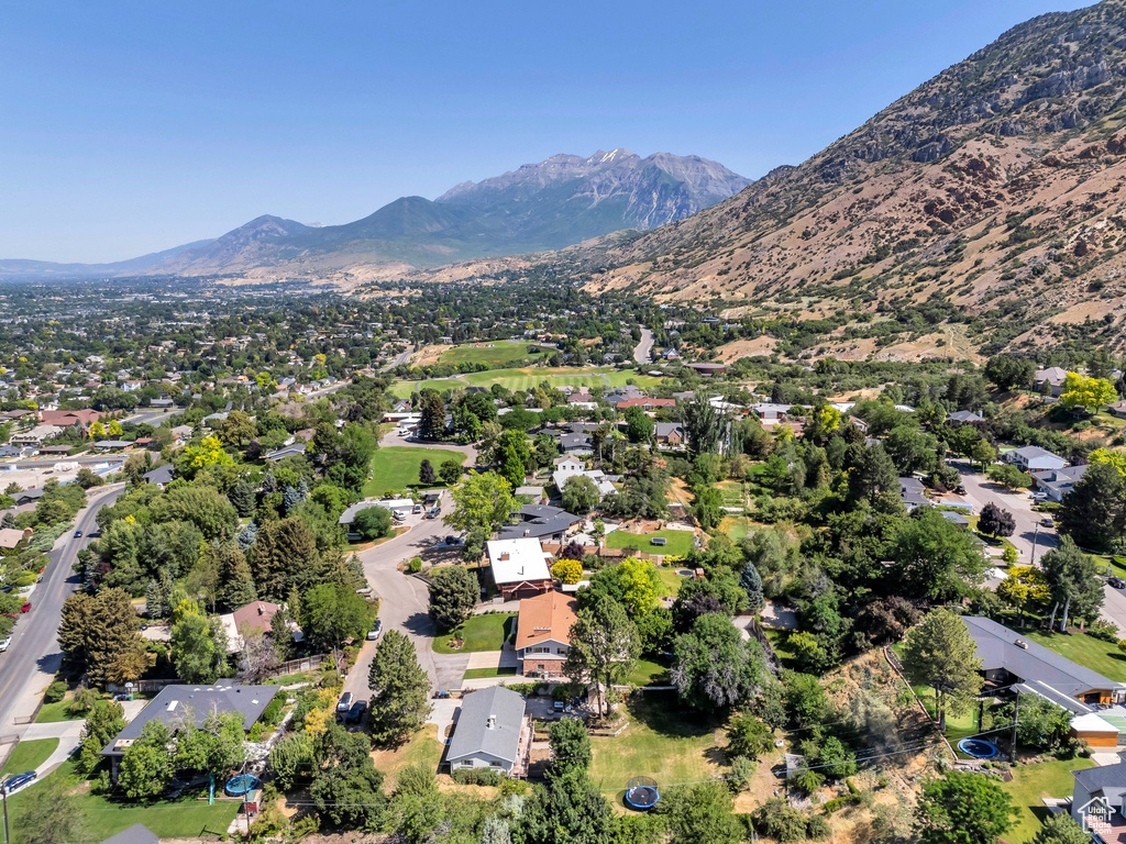 Aerial view of property's location with mountains and nearby suburban area