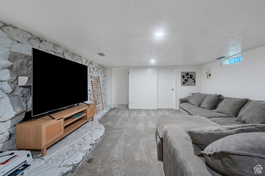 Living room with light carpet and a textured ceiling