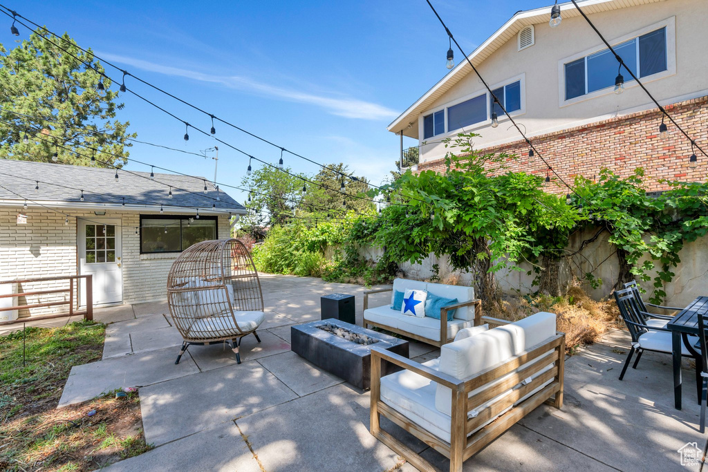 View of patio / terrace with an outdoor living space with a fire pit