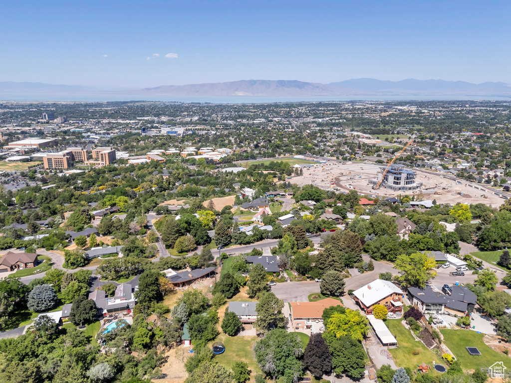Aerial view of property and surrounding area with a mountainous background