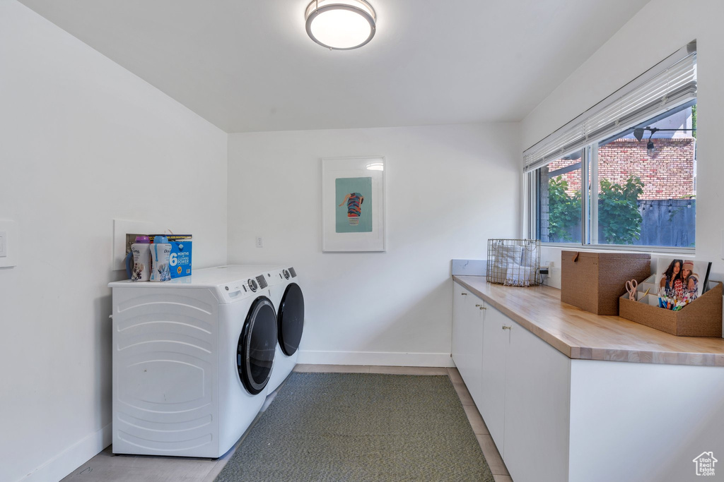 Washroom with washing machine and dryer and cabinet space