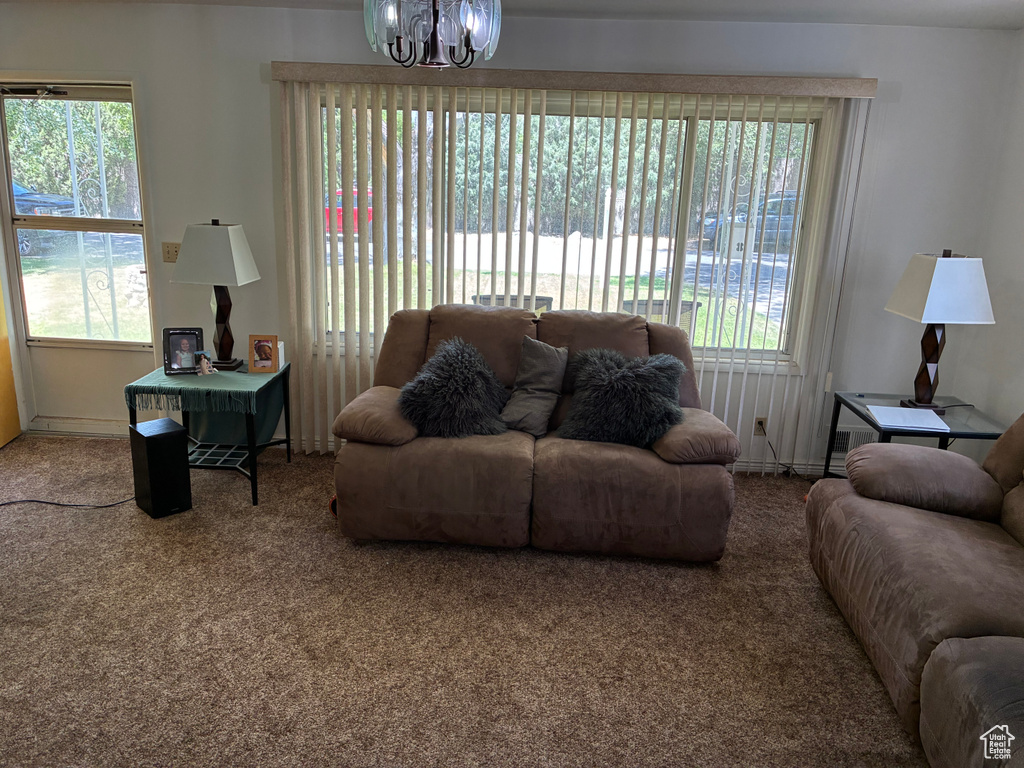 Living room featuring a chandelier and carpet floors