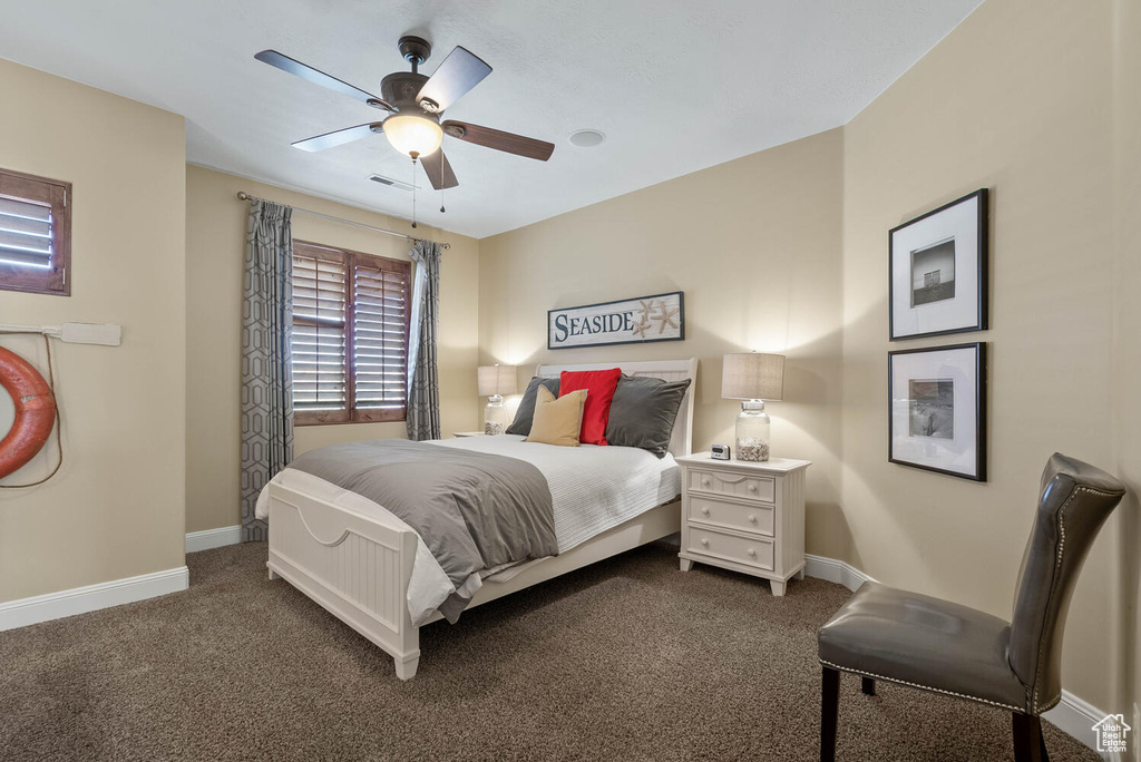 Bedroom featuring dark colored carpet and a ceiling fan