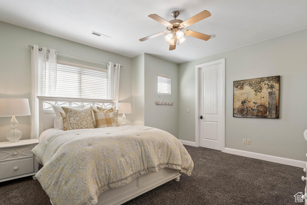 Bedroom featuring dark colored carpet and ceiling fan