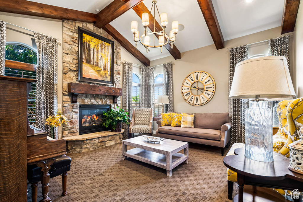 Living room featuring a stone fireplace and a chandelier