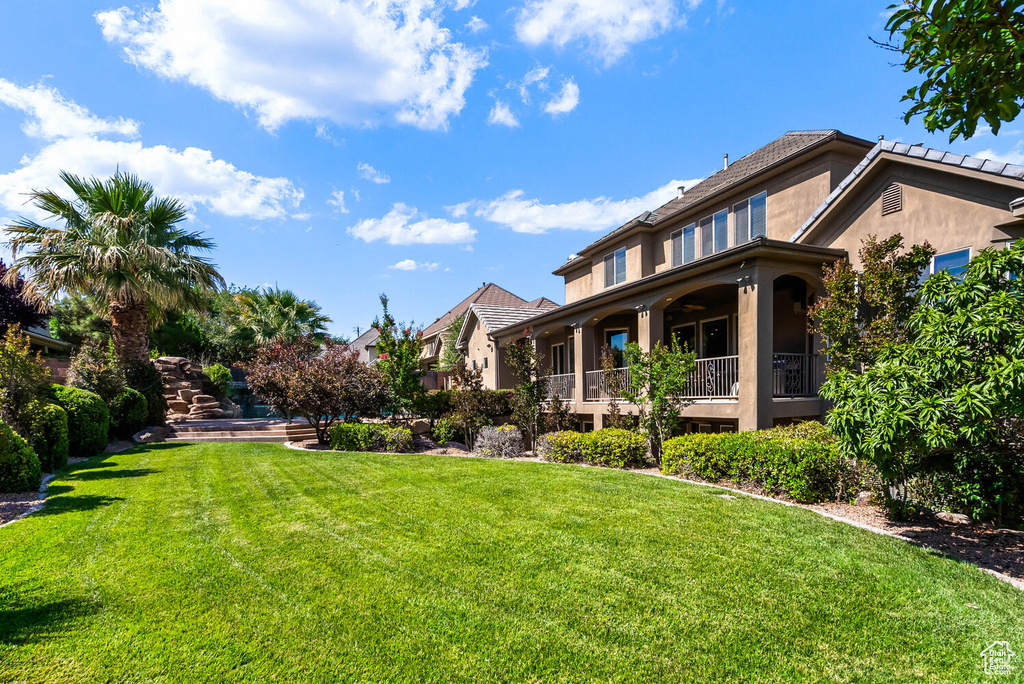 View of green lawn with a residential view