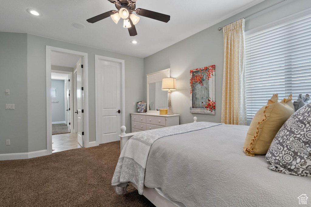 Carpeted bedroom featuring recessed lighting and a ceiling fan