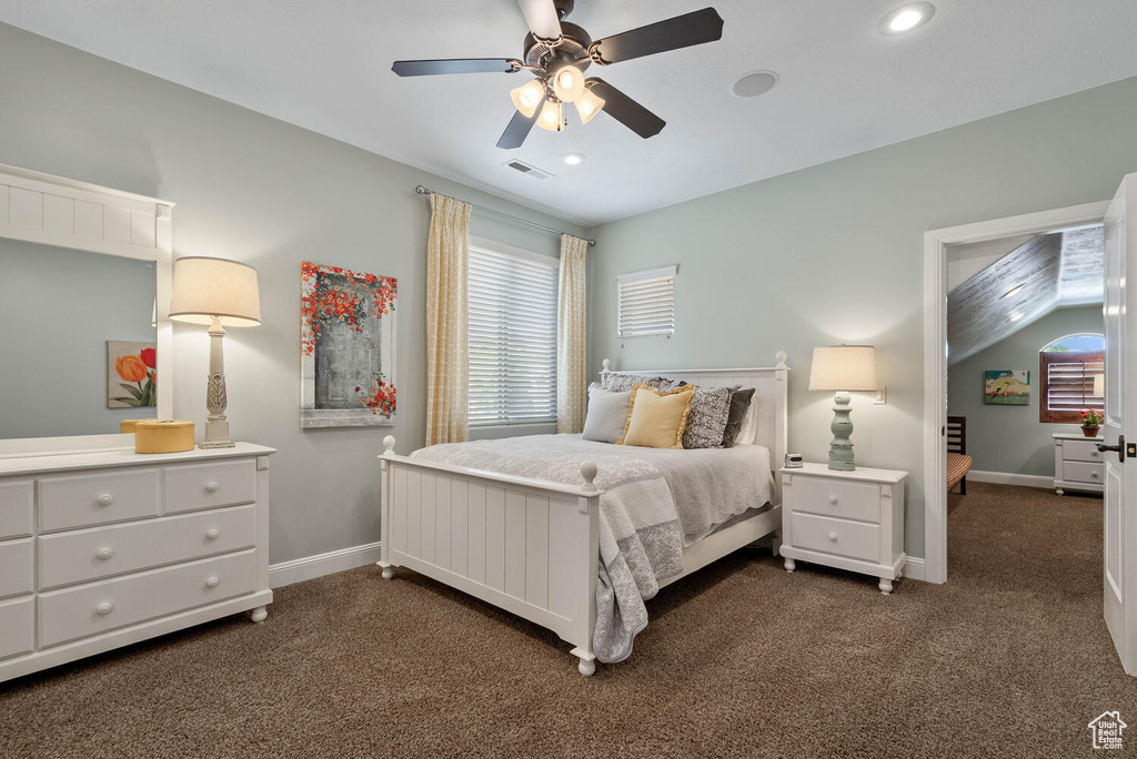 Bedroom with dark colored carpet, recessed lighting, ceiling fan, and vaulted ceiling