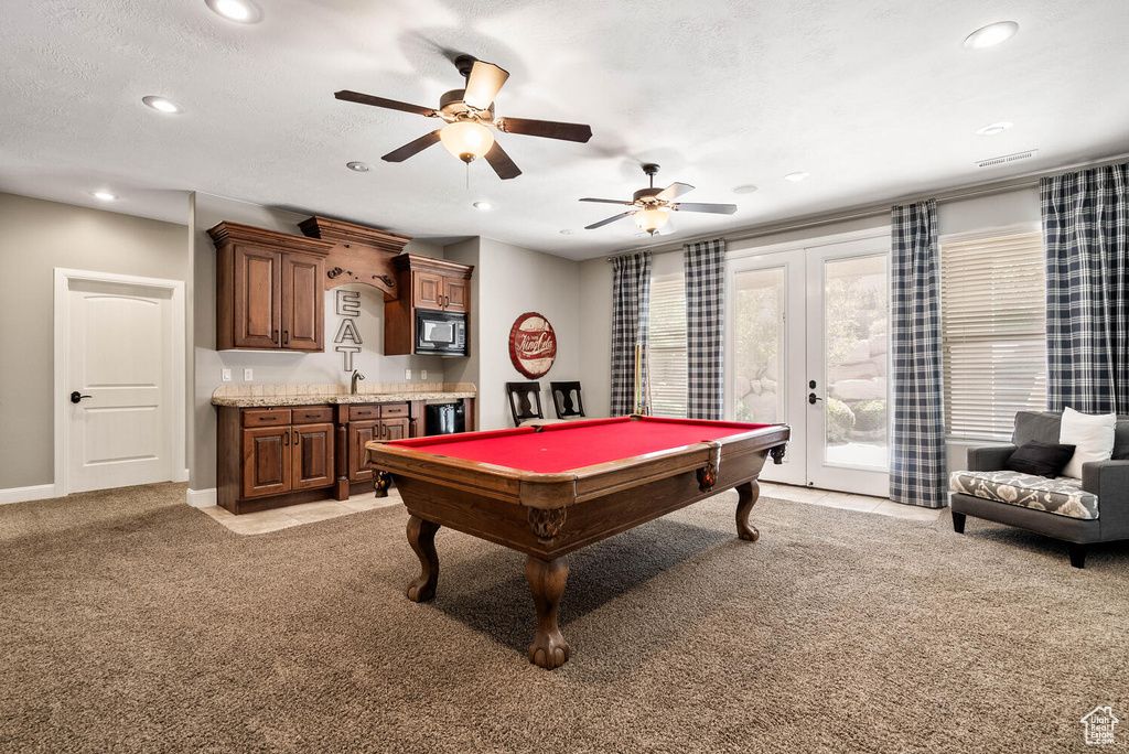 Recreation room featuring recessed lighting, light colored carpet, ceiling fan, billiards, and french doors