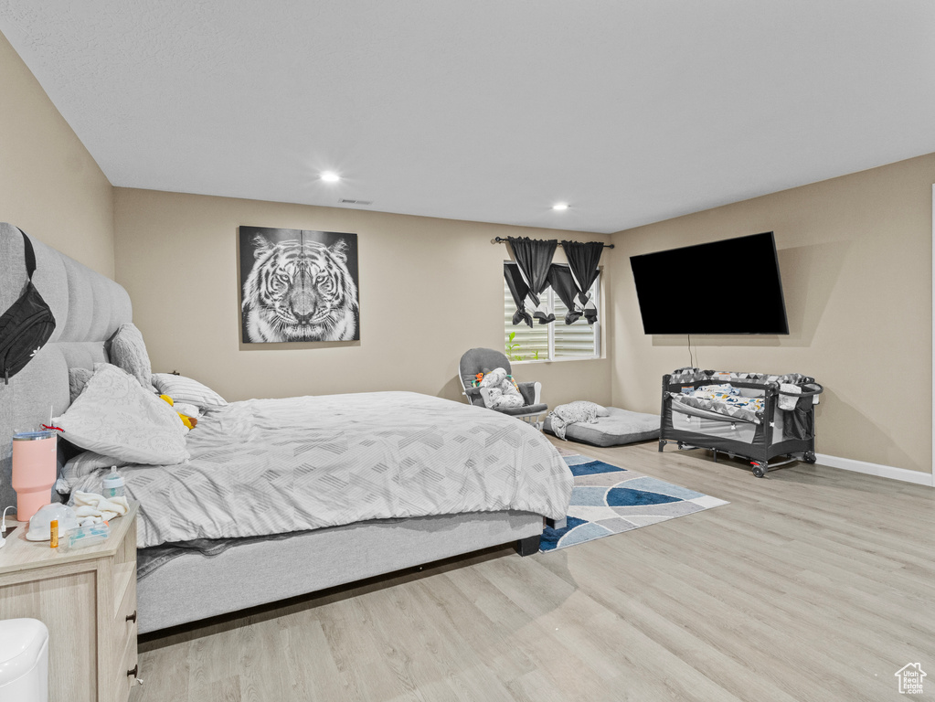 Bedroom with wood finished floors and recessed lighting